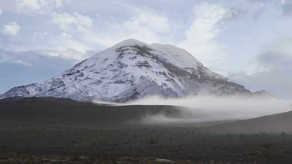 The impressive peak of Chimborazo volcano in Ecuador with morning mist