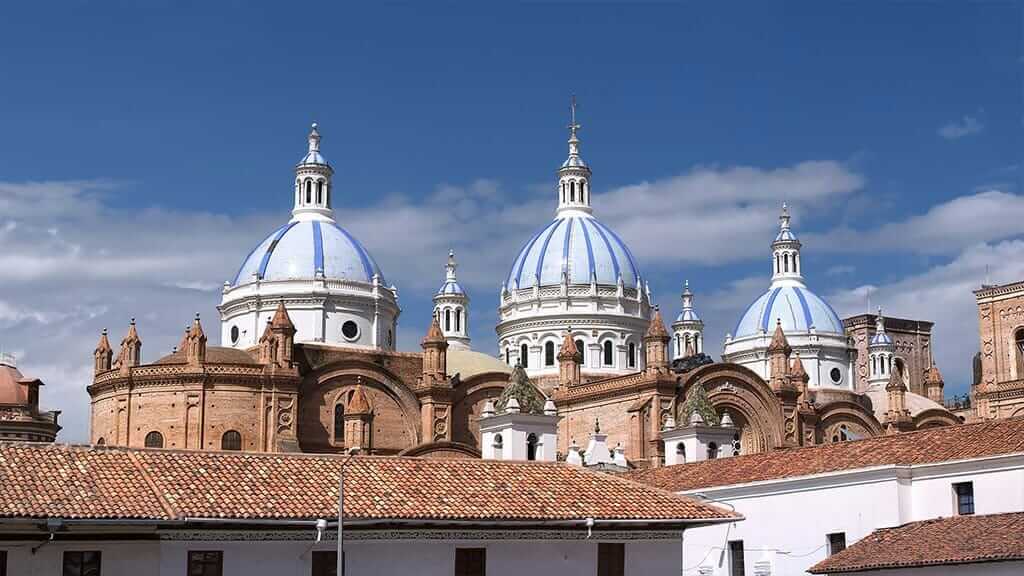blue domes and red brick of cuenca cathedral ecuador