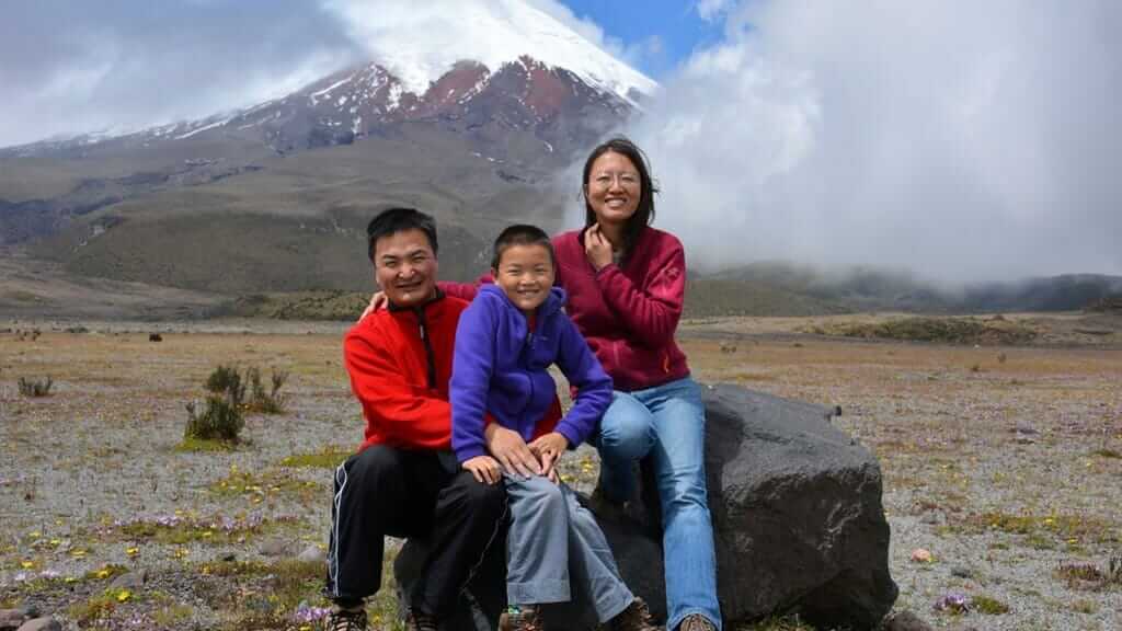 family pose in front of cotopaxi volcano