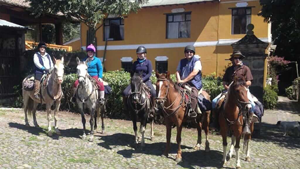 horse riders mounted and ready at la agria hacienda ecuador