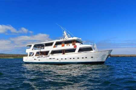 Aqua yacht Galapagos cruise - view of Aqua yacht side profile with blue sky background