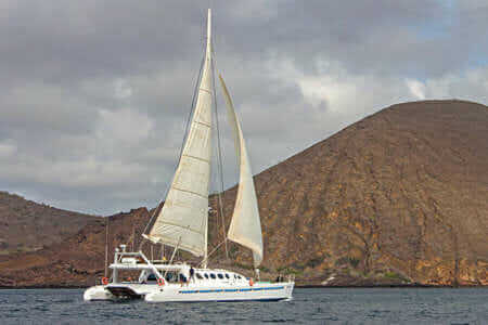 nemo 3 yacht cruising with sails up at the galapagos islands