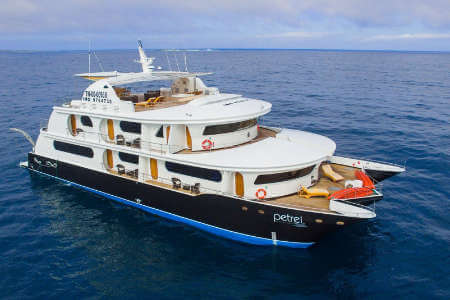 side on view of the Petrel yacht in blue ocean at the galapagos islands