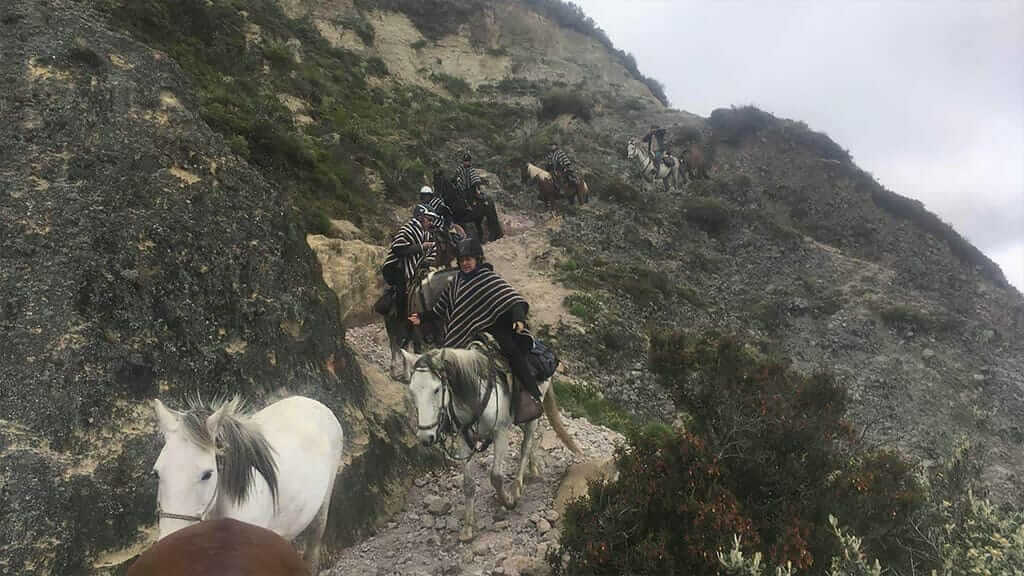 horse riders at quilotoa lagoon ecuador