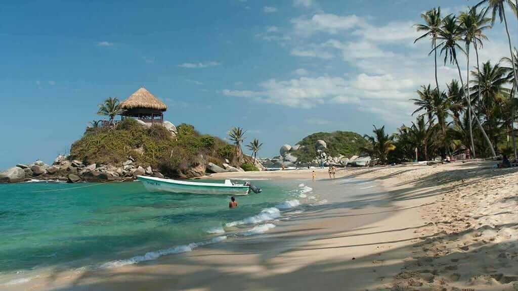 white sand beach and palm trees at Colombia Tayrona Caribbean Coast