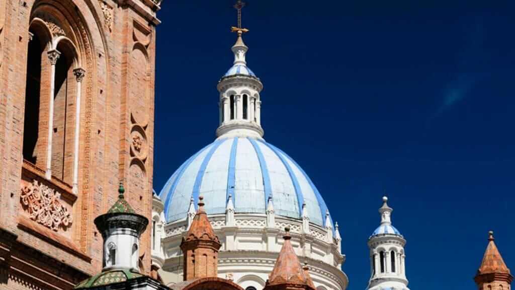 blue domes and red brick of cuenca cathedral ecuador