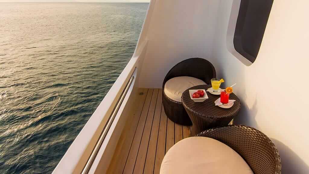 Natural Paradise Galapagos cruise - private balcony with cocktails and ocean views