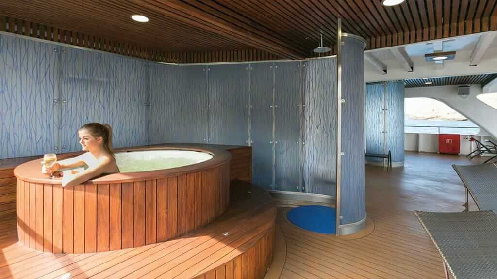 santa cruz ii cruise ship - tourist enjoying a glass of wine in the jacuzzi hot tub