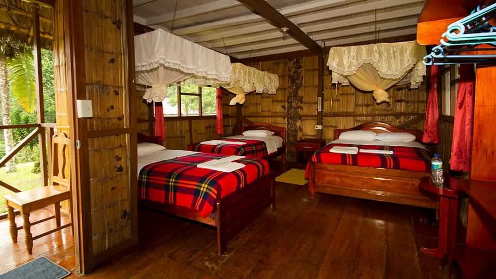 Yarina lodge ecuador - cabaña de habitación triple con mosquiteros y paredes de bambú