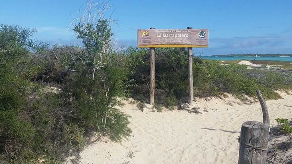 entrance sign a Garrapatero beach santa cruz galapagos