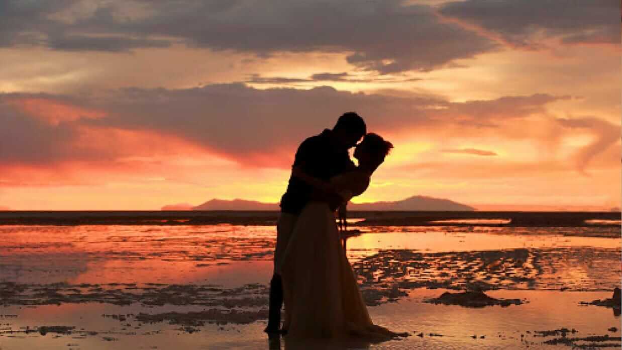 south america honeymoon destinations - a romantic couple of the beach at sunset
