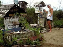 a tourist leaves his post card at post office bay on floreana island galapagos