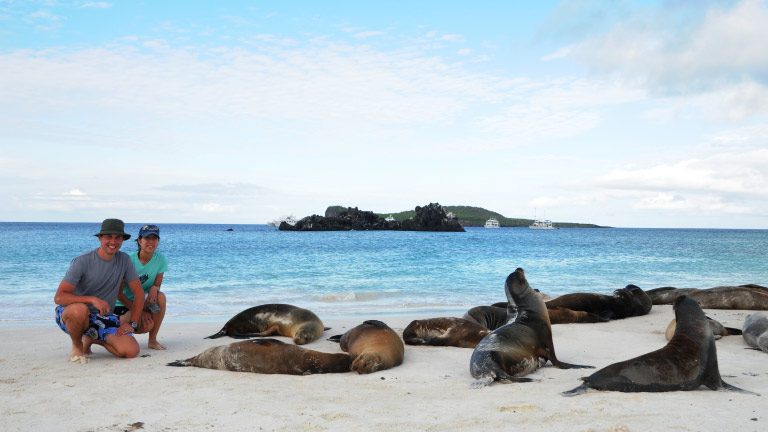 Happy-passengers-in-Galapagos-next-to-sea-lions