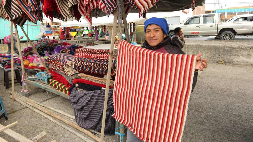 Saquisili-Market seller with textiles in ecuador