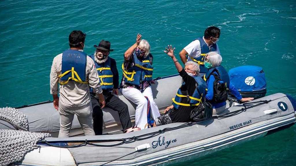 happy galapagos tourists in panga zodiac boat