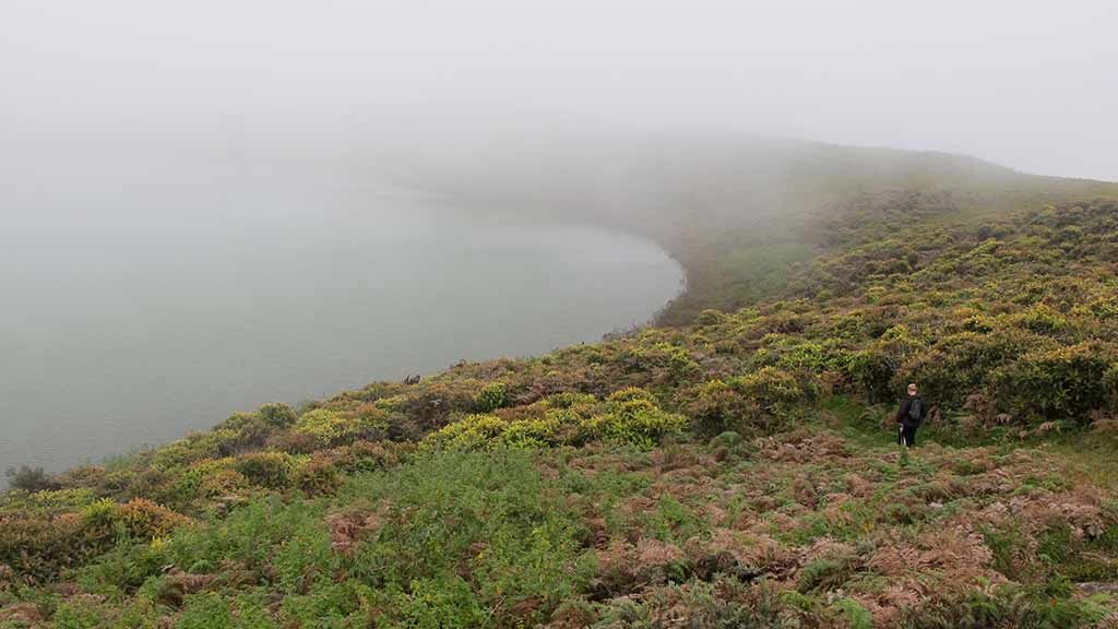 mist sweeps in at el-junco-crater lake galapagos
