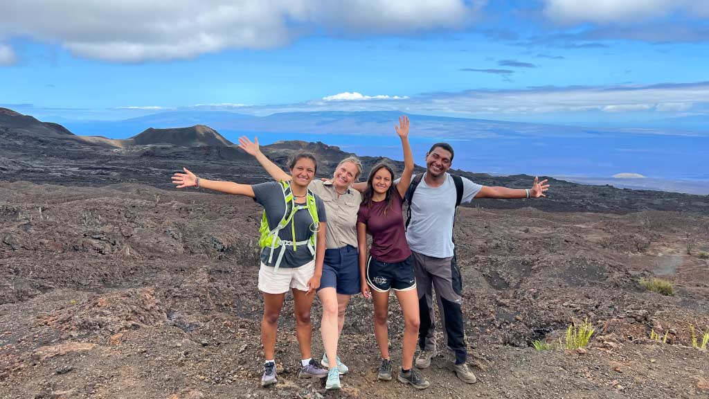 best time to visit Galapagos - family atop sierra negra volcano in good weather