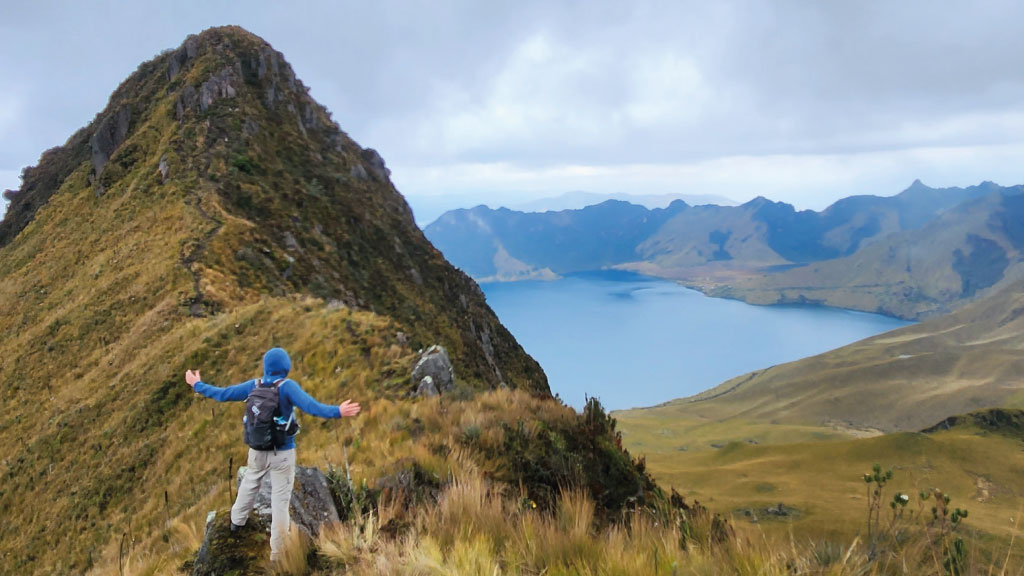 hiker on fuya-fuya-volcano with view of mojanda lakes otavalo ecuador