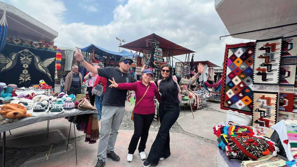 happy-tourist-in-otavalo-market ecuador