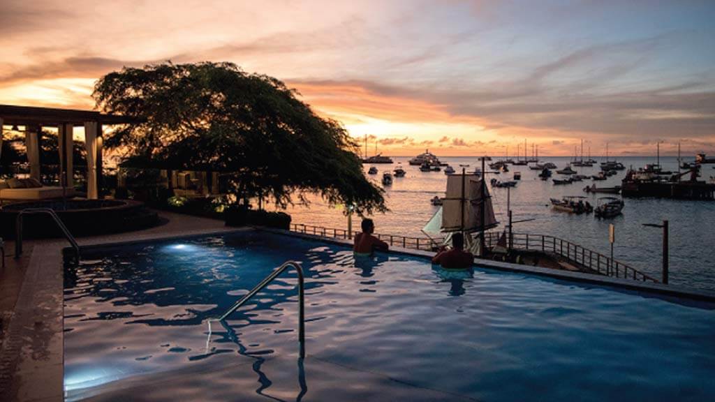 tourists enjoy infinity pool at Hotel Indigo san Cristobal galapagos