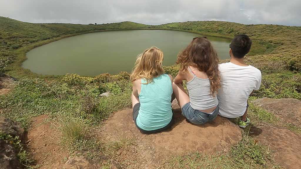 tourists-appreciate view of el-junco-lake galapagos