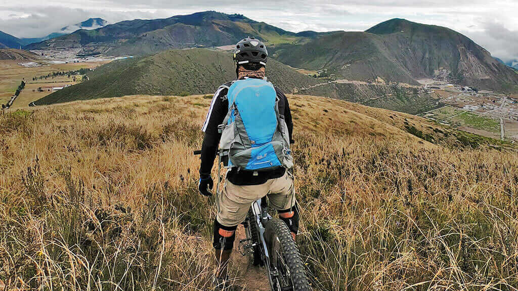 mountain biker at pululahua crater ecuador
