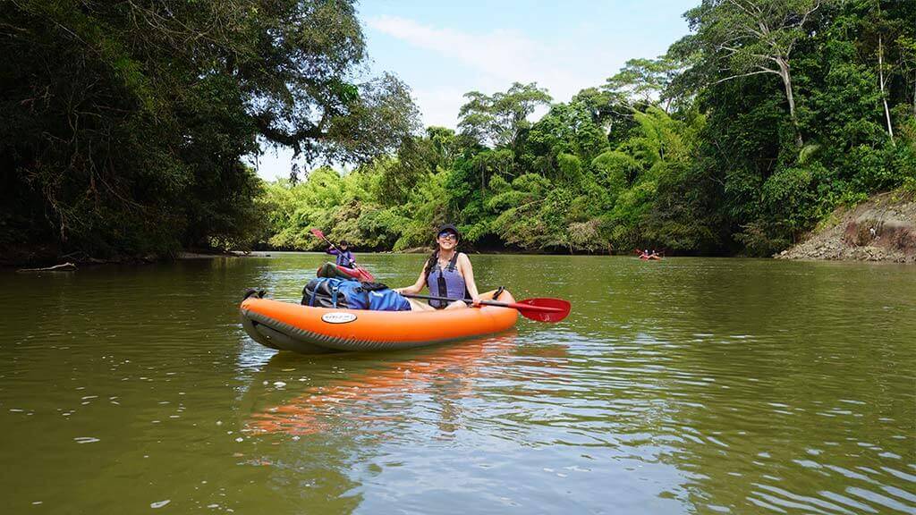 happy tourist kayaking arajuno river in ecuador