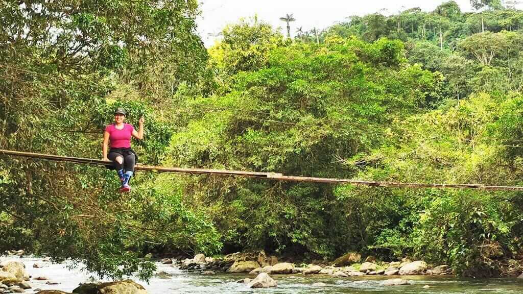 mashpi-community-ecuador tourist on bridge over mashpi river